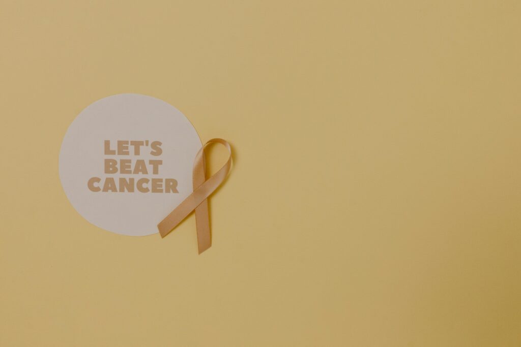 Minimalist design featuring a ribbon and 'Let's Beat Cancer' message for cancer awareness.